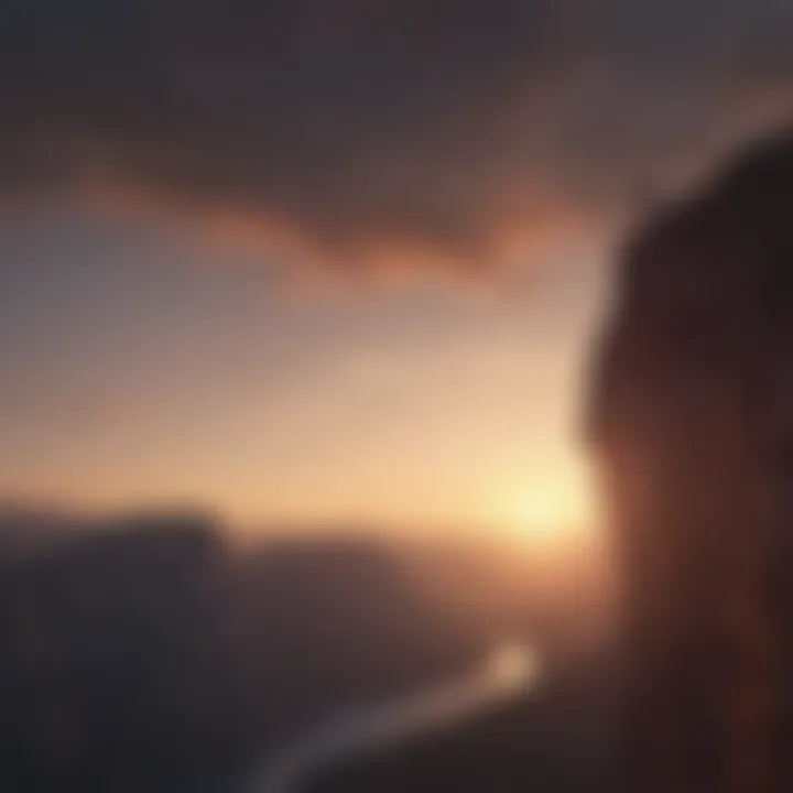 Silhouette of a person standing at the edge of a cliff facing the sunrise