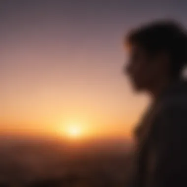 A silhouette of a person gazing at a sunrise with a quote